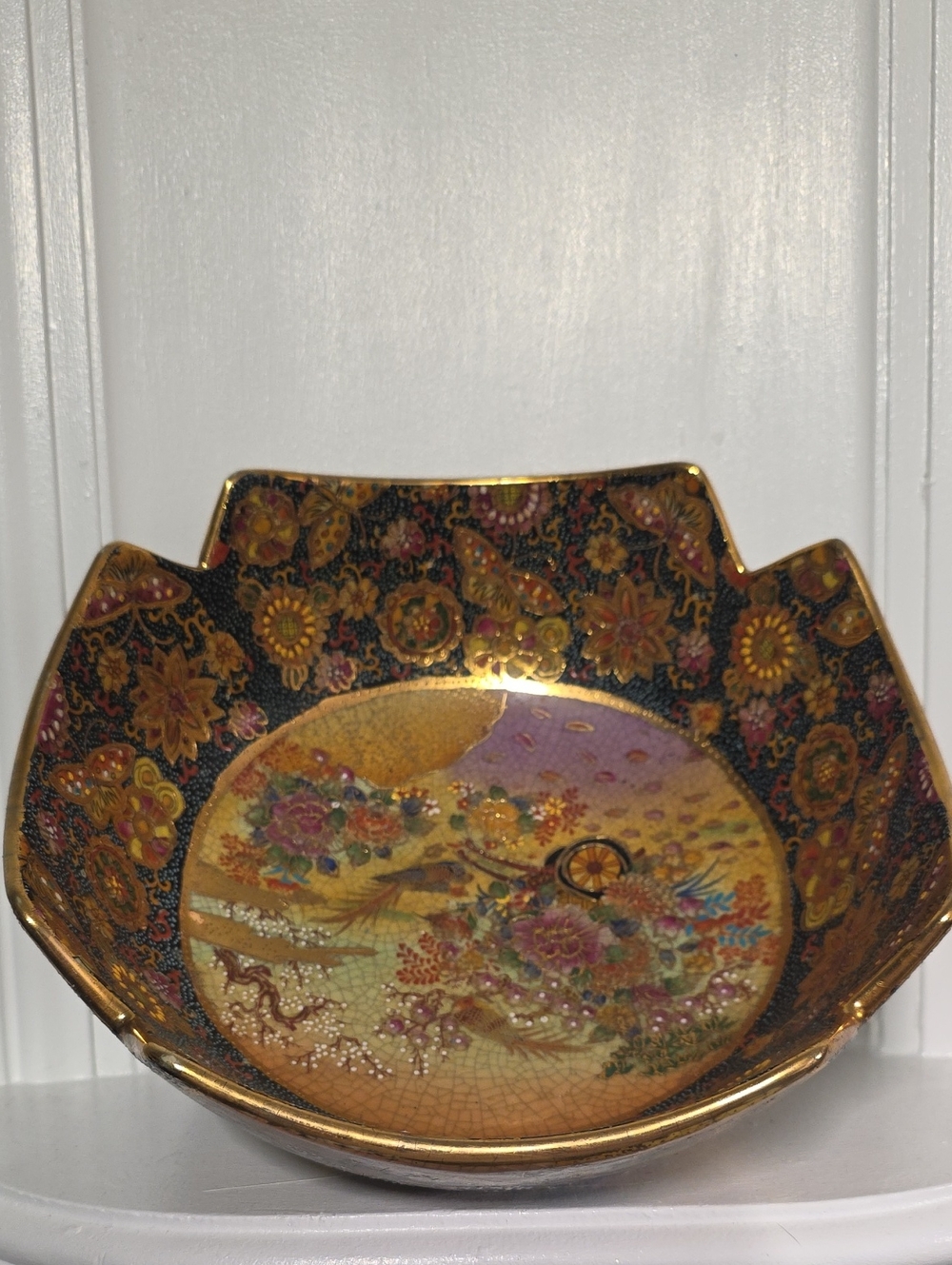 vintage Satsuma-style or hand-painted decorative bowl featuring a black and gold